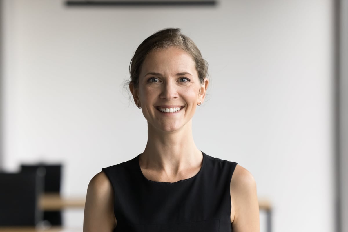 Head shot portrait attractive satisfied businesswoman looking at camera, professional woman smiling