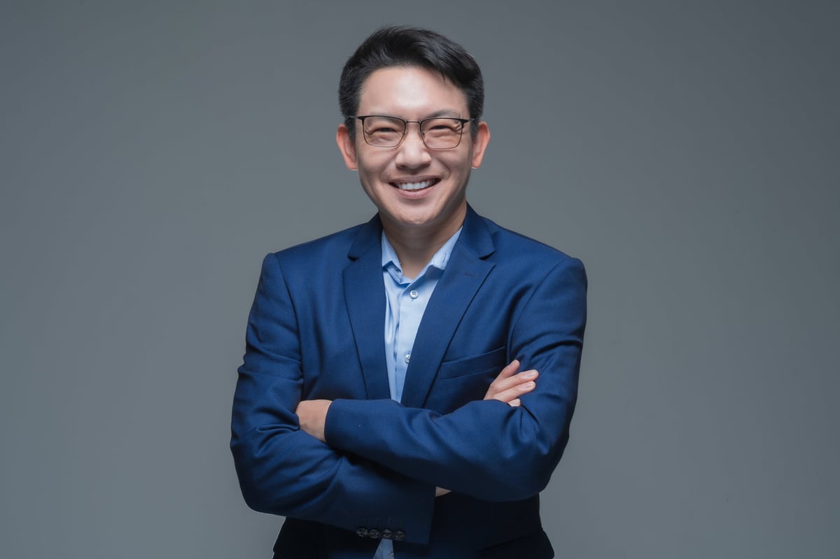 Confident smiling businessman wearing glasses and blue suit, professional portrait