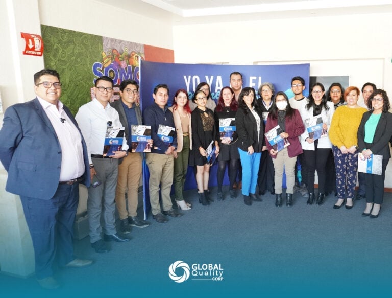Group of diverse professionals posing together at a Global Entrepreneurship Week event with branded backdrop and banners
